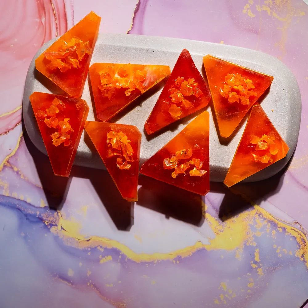 Top-angle Orange Mango kohakutou, mango-orange shards with glossy facets.