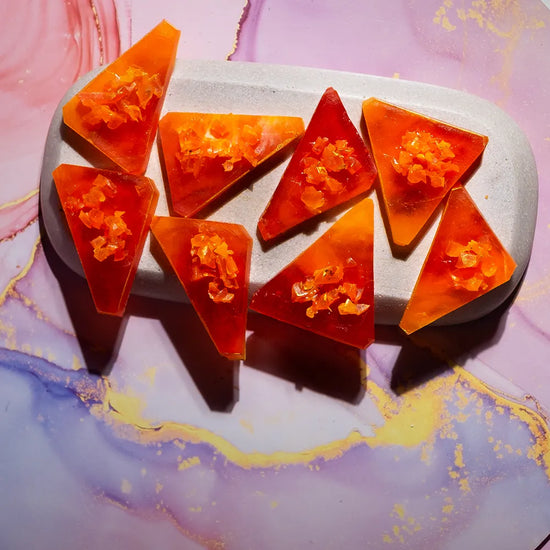 Top-angle Orange Mango kohakutou, mango-orange shards with glossy facets.
