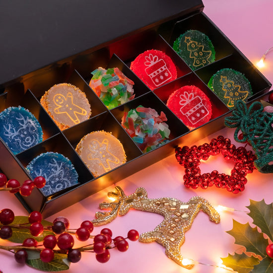 Decorative Christmas Crystal Candies  in a box with festive decorations on a pink background