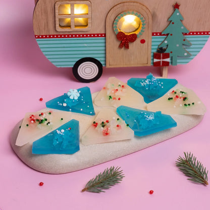 Blue and white Japanese style crystal candy on pink background with a Christmas toy caravan.