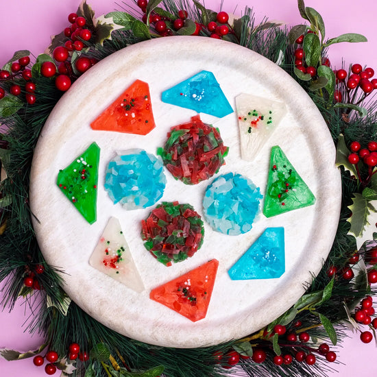Decorative plate with a colourful crystal candy on a Christmas wreath background